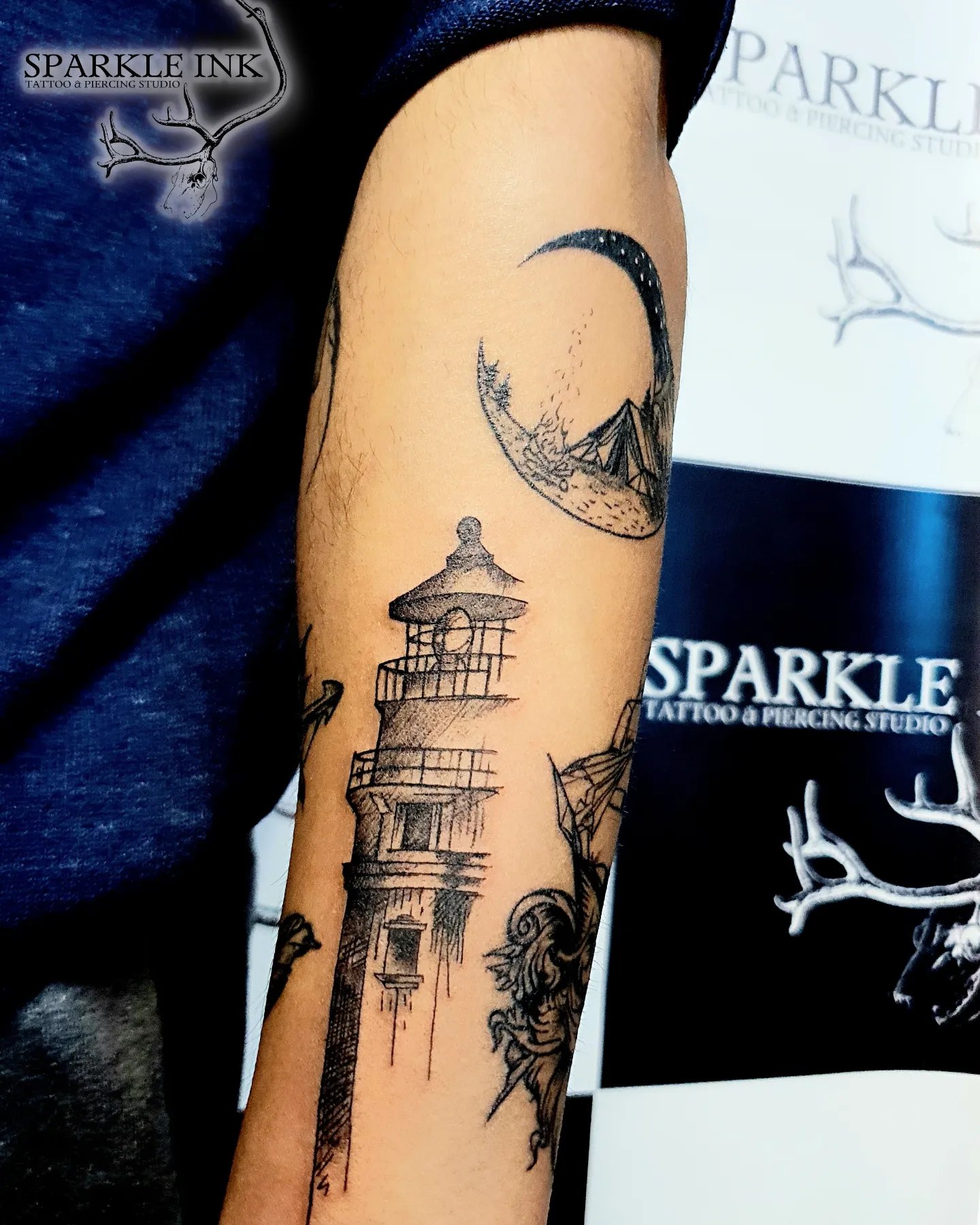 Lighthouse and crescent moon tattoo at Sparkle Ink Tattoos