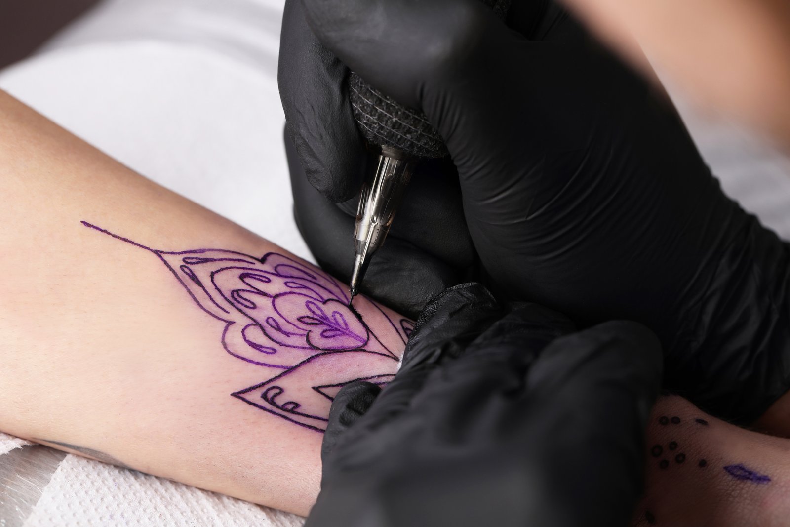 Tattoo artist inking session at Sparkle Ink Tattoos